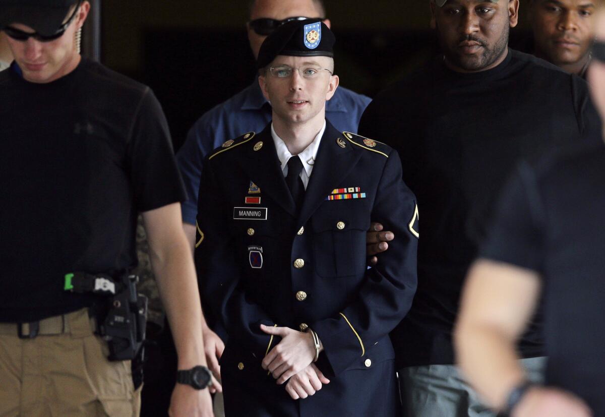 Army Pfc. Bradley Manning is escorted out of a courthouse in Fort Meade, Md.