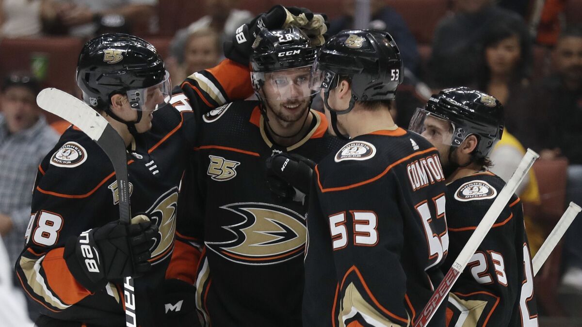 Ducks' Max Comtois (53) celebrates his goal with teammates during the second period of a preseason game against the Kings on Sept. 26 in Anaheim.