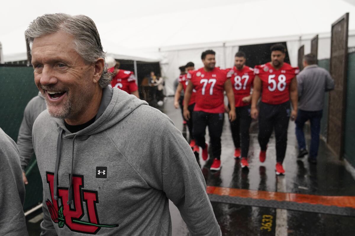 Utah coach Kyle Whittingham smiles as he walks out with his players following Rose Bowl media day on Saturday.