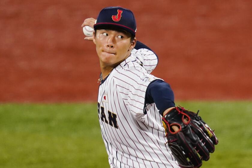 Japan's Yoshinobu Yamamoto pitches during the first inning of a semi-final baseball game.