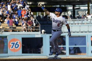 Los Angeles Dodgers' David Peralta gestures as he rounds second after hitting a two-run home run.