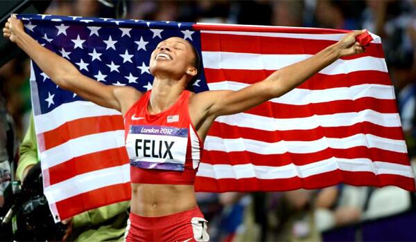 USA's Allyson Felix carries the American flag after winning the 200 meters at the 2012 London Olympics. www.lasports.org.
