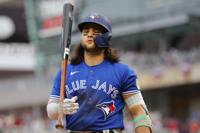 Toronto Blue Jays' Bo Bichette walks to the dugout after striking out against the Minnesota Twins during the sixth inning of Game 2 of an AL wild-card baseball playoff series Wednesday, Oct. 4, 2023, in Minneapolis. (AP Photo/Bruce Kluckhohn)