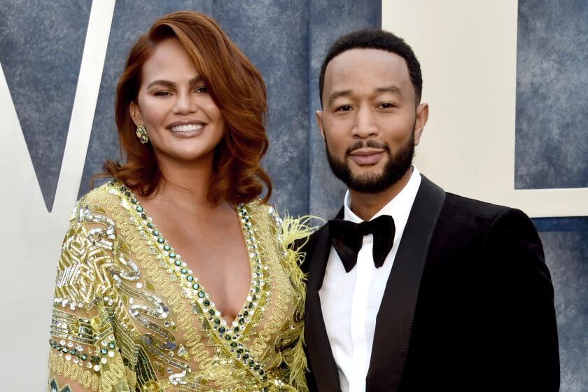 FILE - Chrissy Teigen, left, and John Legend arrive at the Vanity Fair Oscar Party in Beverly Hills, Calif., on March 12, 2023. Teigen and Legend have welcomed baby No. 4, a boy, born via surrogate on June 19. (Photo by Evan Agostini/Invision/AP, File)