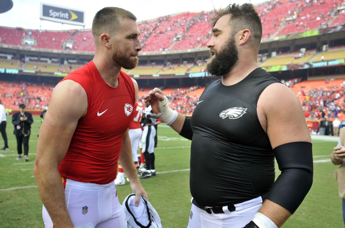 Chiefs tight end Travis Kelce (left) talks with brother, Eagles center Jason Kelce, after their game in 2017.