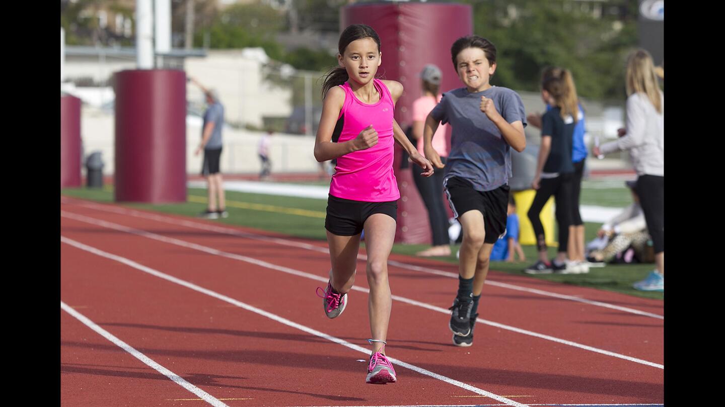 Ten-year-old Maya Voss eyes the finish line in the division 7, 400 meter run during the Laguna Beach annual youth track and field meet at Laguna Beach High on Friday.