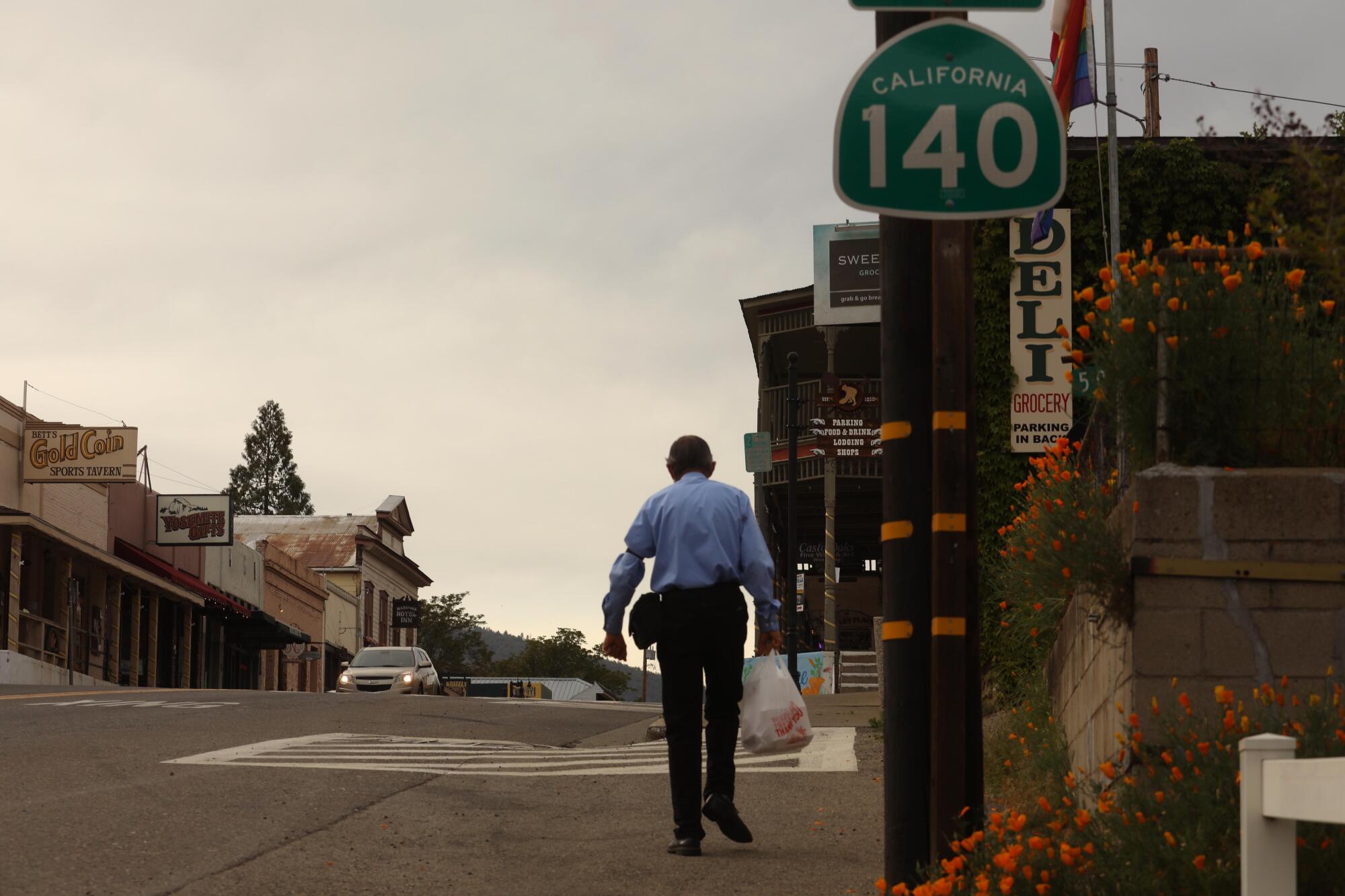 Bill Evans walks home along Highway 140 in Mariposa