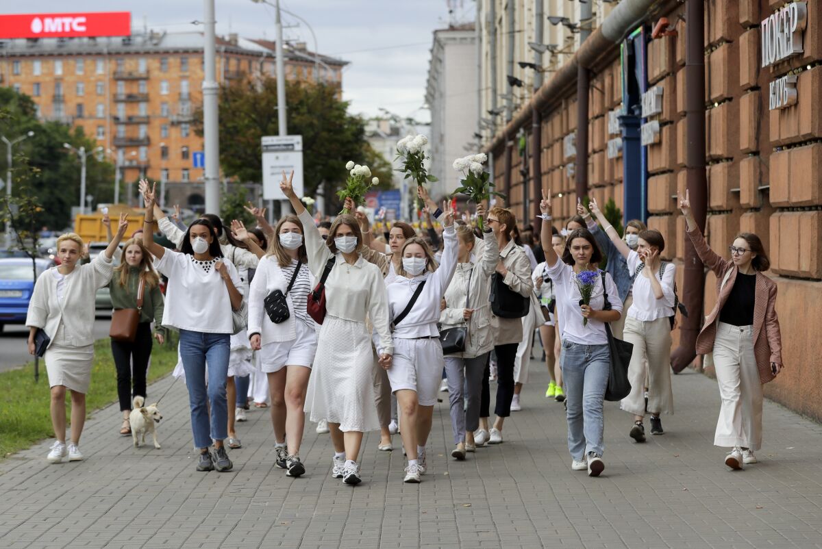 About 200 women march in solidarity with protesters injured in the latest rallies against the results of the country's presidential election in Minsk, Belarus, Wednesday, Aug. 12, 2020. Belarus officials say police detained over 1,000 people during the latest protests against the results of the country's presidential election. (AP Photo)