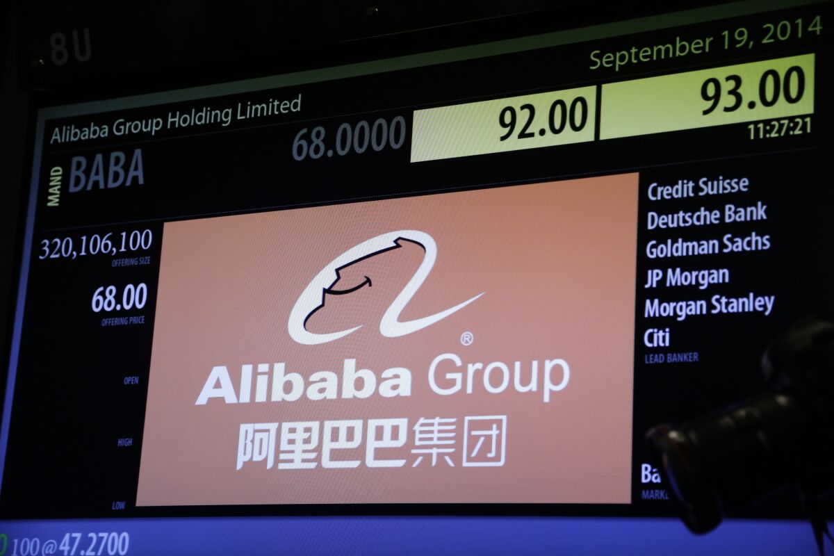 FILE - An electronic screen posts early pricing for Alibaba stock before it finally began trading during the company's IPO at the New York Stock Exchange, Friday, Sept. 19, 2014 in New York. Chinese e-commerce firm Alibaba said Monday, Aug. 1, 2022, that it wants to keep its shares listed in both New York and Hong Kong, days after U.S. regulators included it in a list of companies that may be delisted for not complying with auditing requirements.(AP Photo/Mark Lennihan, File)