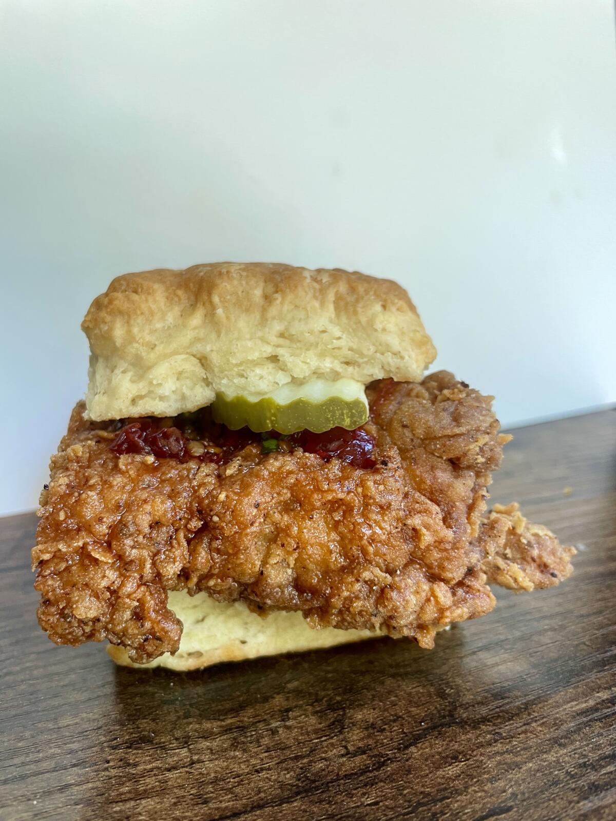 Beulah's biscuit with fried chicken, chili honey, shaved onion and pickles