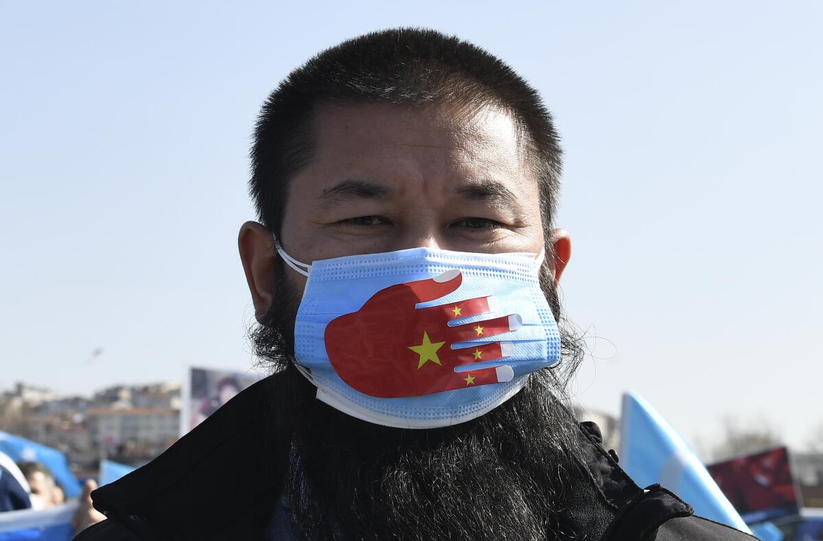 A man wears a mask at a protest.