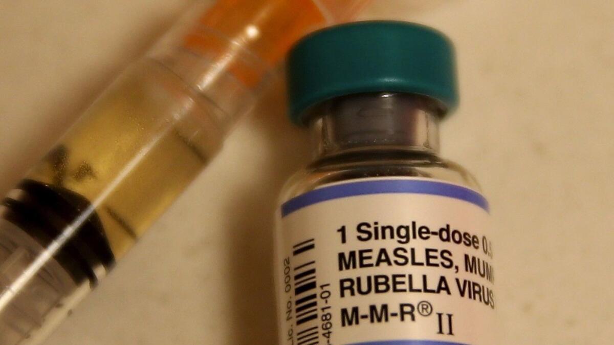 In this photo illustration, a bottle containing a measles vaccine is shown.