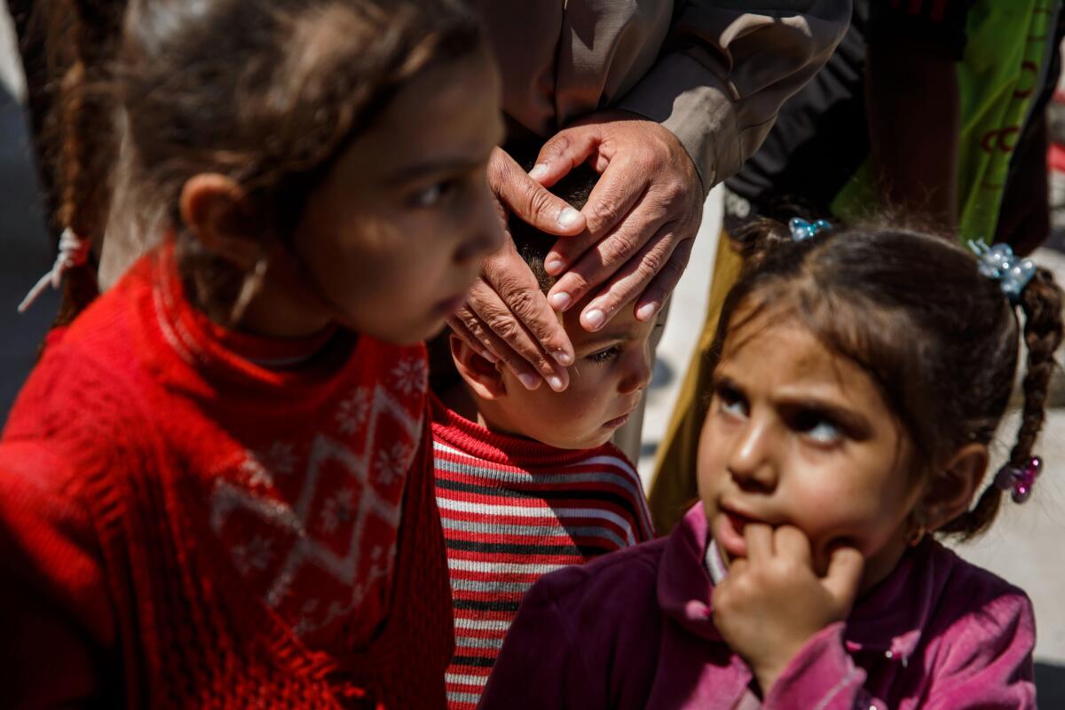 Relatives comfort 2-year-old Ali Jasim Mohammed who they say was orphaned in an airstrike that killed 11 people in east Mosul’s Baysan neighborhood on Jan. 21. The U.S.-led coalition conducted strikes that day, but was not investigating.