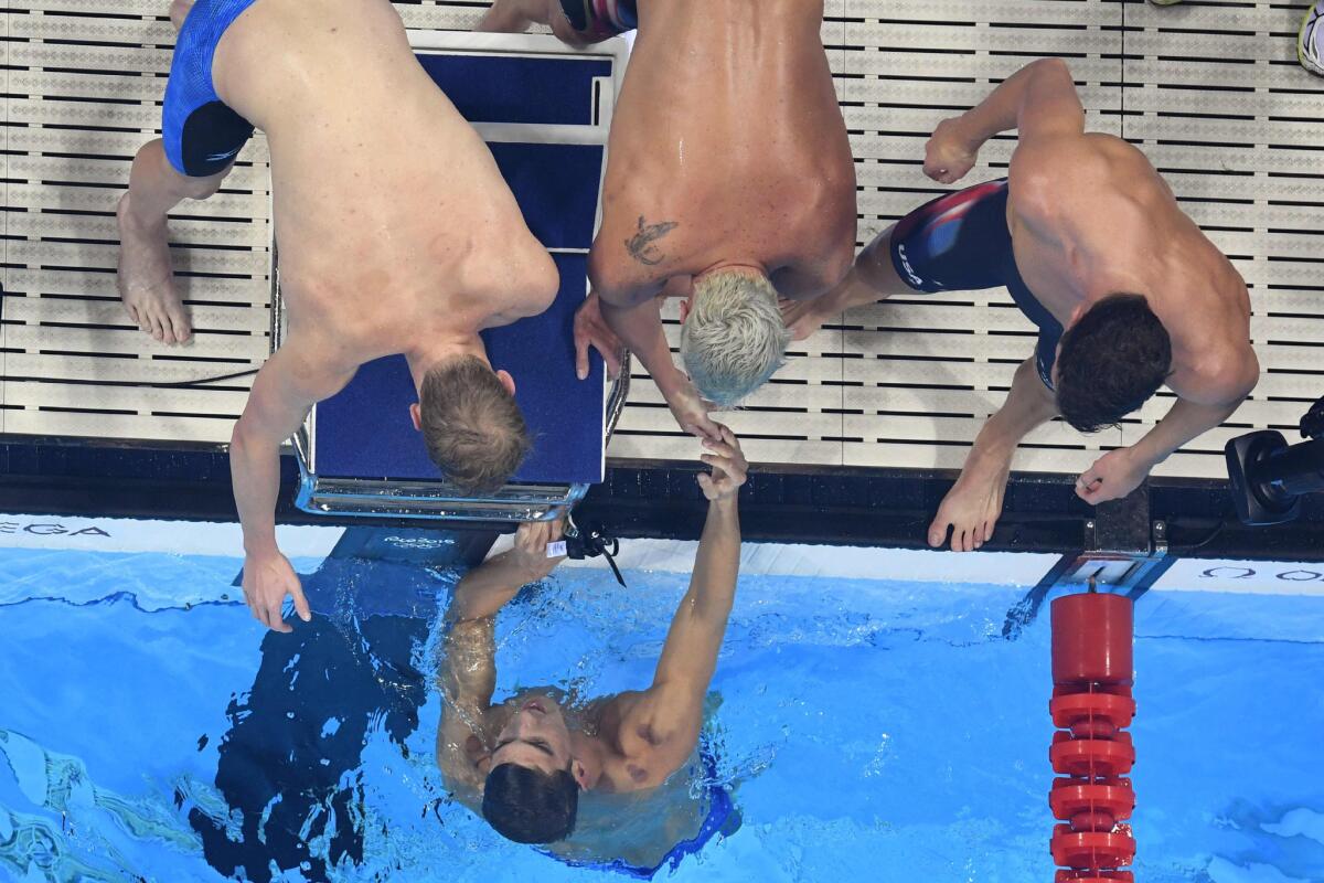 U.S. swimmer Michael Phelps (bottom) celebrates with his teammates after Team USA won the men's 800-meter freestyle relay on Aug. 9.