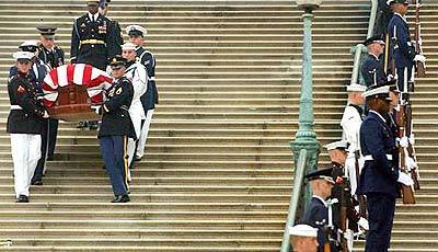 An honor guard carries the casket of former President Reagan from the Capitol on its way to the National Cathedral.