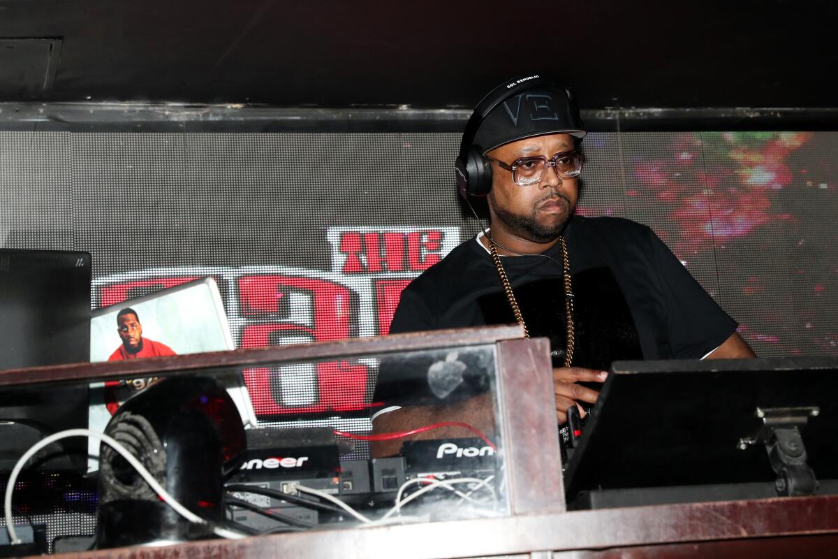 A DJ spinning records on a stage