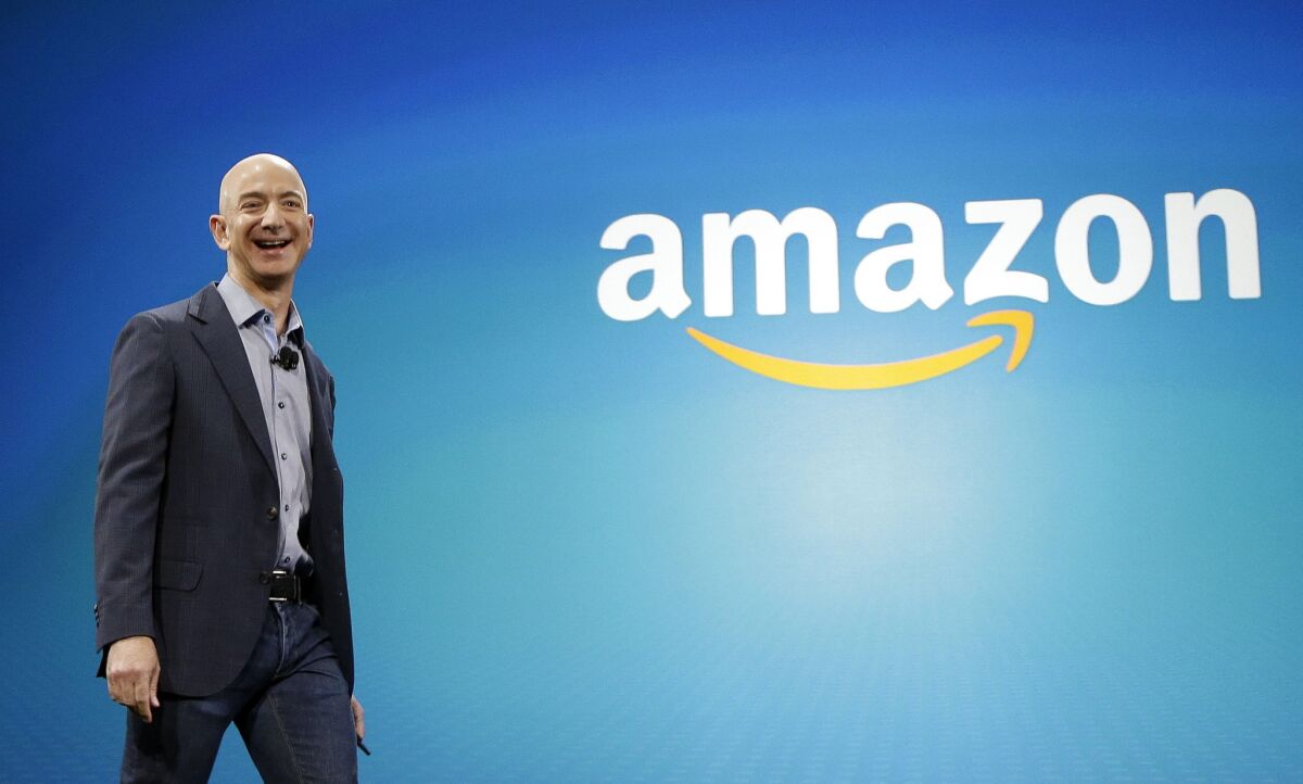 Amazon CEO Jeff Bezos walks onstage for the launch of the Fire Phone last year in Seattle.