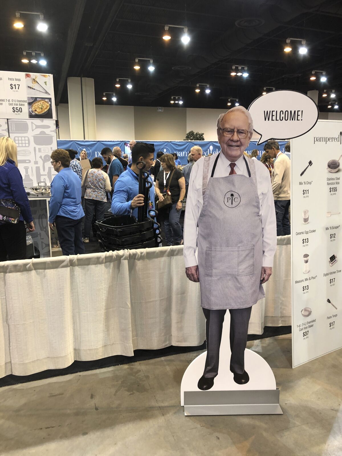 A cutout of Berkshire Hathaway CEO Warren Buffett greets shareholders at the Pampered Chef booth at the company's annual meeting, Friday, APril 29, 2022, in Omaha, Neb.. Tens of thousands of shareholders are expected Saturday to attend the company's first in-person meeting since the pandemic began. (AP Photo/Josh Funk)
