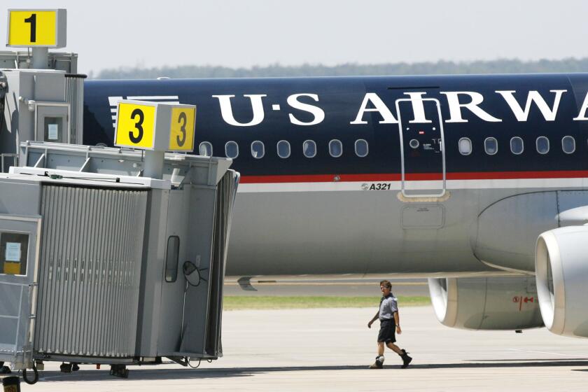 A US Airways plane sits next to the terminal at Will Rogers World Airport in 2006 after it was diverted to Oklahoma City because of an incident involving a disruptive passenger.
