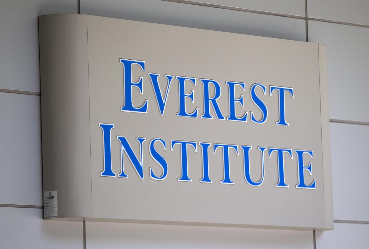 An Everest Institute sign is seen in an office building in Silver Spring, Md., in 2014. The federal government will erase portions of the debt of some of the students who attended the now-defunct Corinthian Colleges.