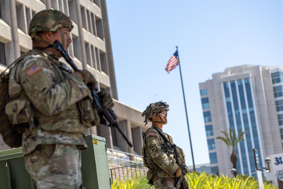 California National Guard members stand outside the Santa Ana Federal Building in Santa Ana on June 18.