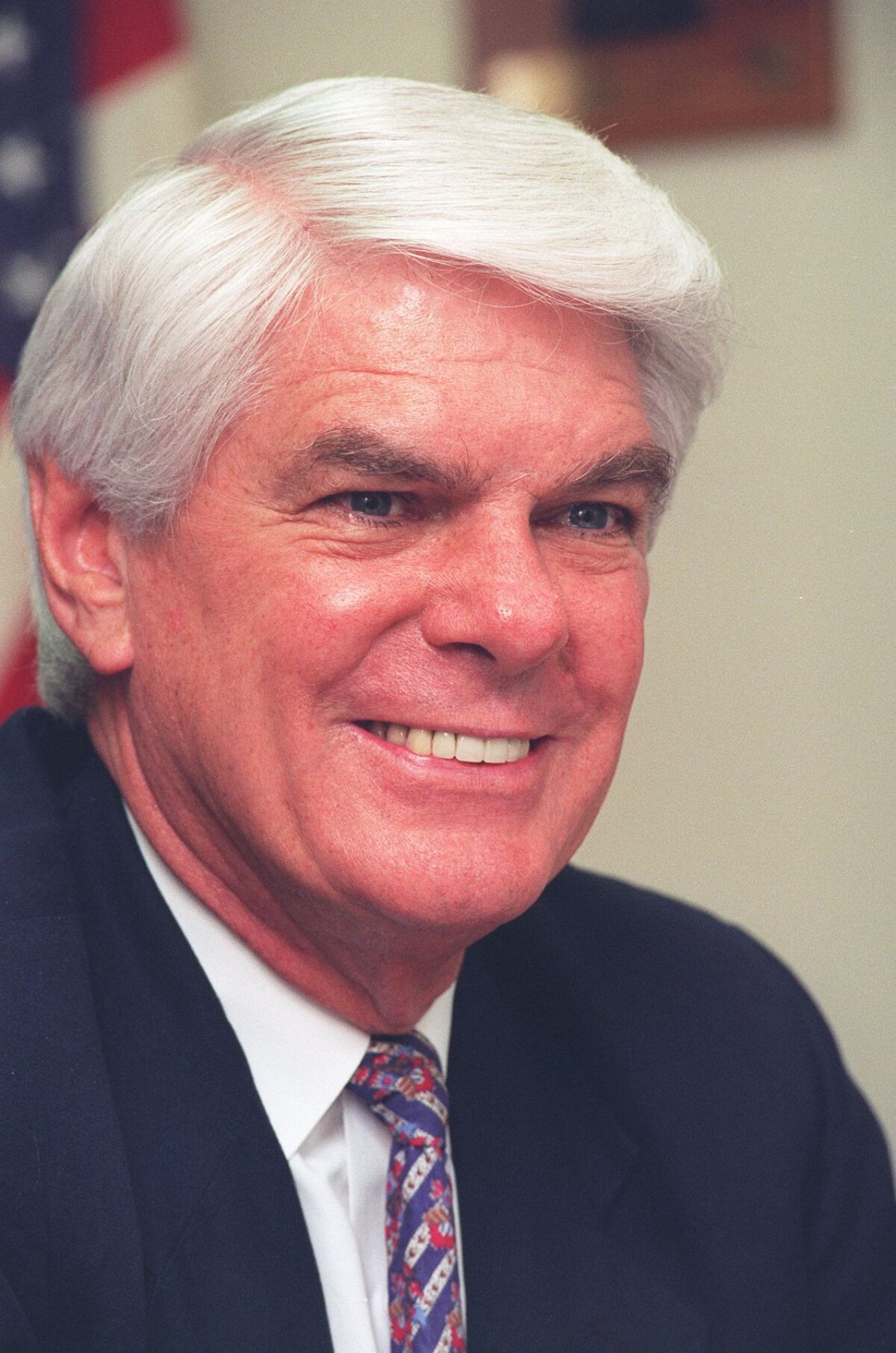 Congressman Jerry Lewis, wearing a red, white and blue tie, smiles.