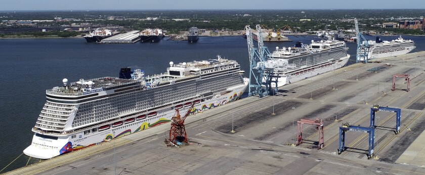 FILE - In this May 4, 2020 file photo, Norwegian cruise ships are docked at Portsmouth Marine Terminal in Portsmouth, Va. Norwegian Cruise Line is announcing plans to resume sailing after being shut down for more than a year by the pandemic. Norwegian said Tuesday, May 4, 2020, that it plans trips in late July in the Greek islands and in August in the Caribbean. (Stephen M. Katz/The Virginian-Pilot via AP, File)