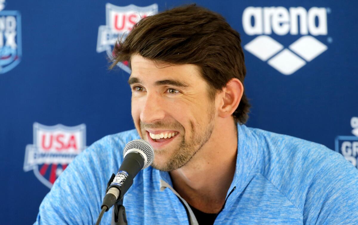 Michael Phelps speaks during a news conference in Mesa, Ariz., on Wednesday. Phelps is returning to competitive swimming after a two-year retirement.
