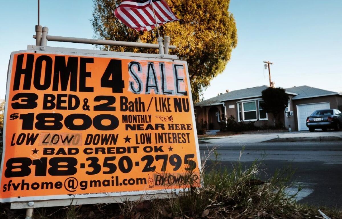 Long-term mortgage rates fell this week, making it less expensive to buy a home. Above, a Los Angeles house up for sale in January.