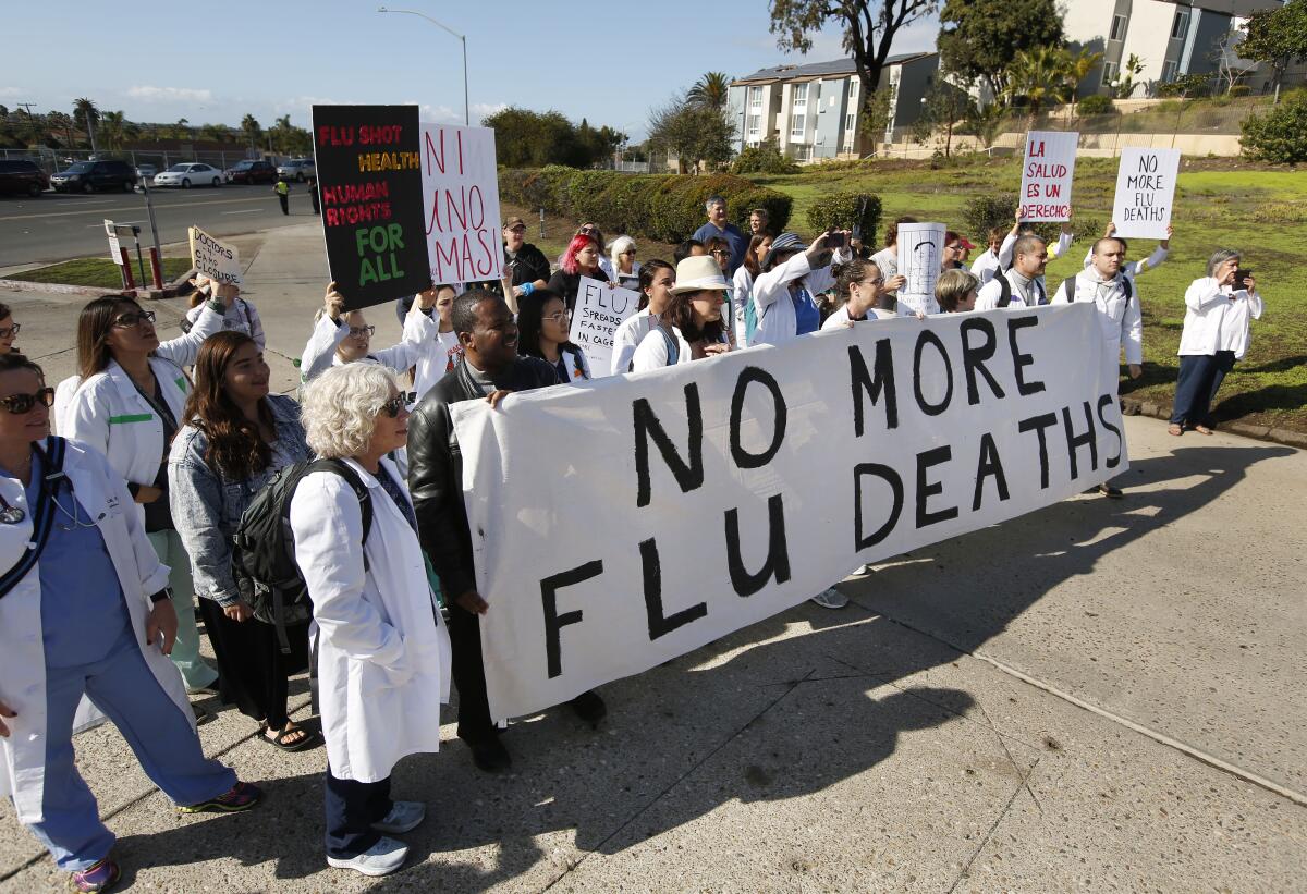 Doctors and other healthcare providers from Doctors for Camp Closure stand outside a U.S. Customs and Border Protection facility in San Ysidro, Calif., hoping to get access to the facility to give flu shots to detained migrants on Monday.