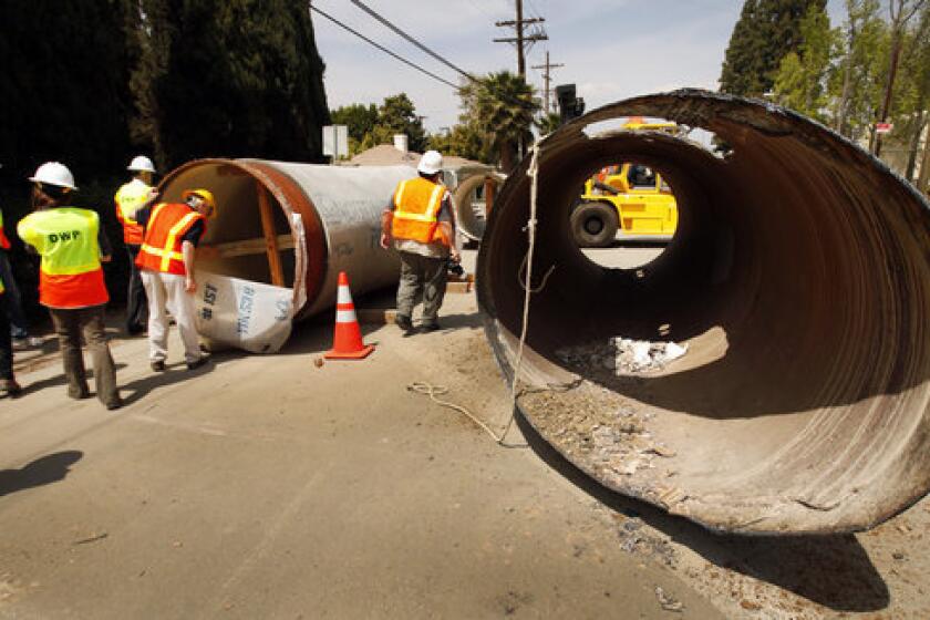 Los Angeles Department of Water and Power officials survey construction along Coldwater Canyon Blvd. in Studio City.