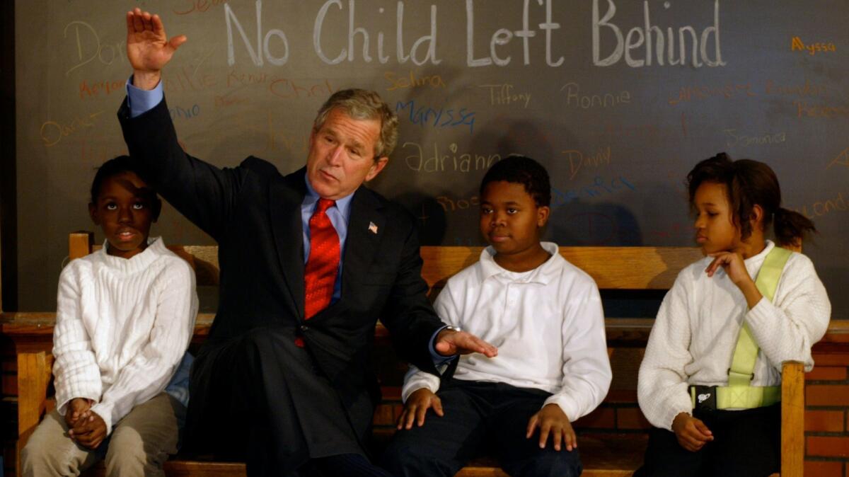 President Bush spends time with students at Pierre Laclede elementary school in St. Louis on Jan. 5, 2004, as part of a celebration of the two year anniversary of the "No Child Left Behind Act."