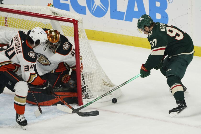 Anaheim Ducks' Jamie Drysdale (34) breaks up a wraparound shot attempt on Ducks goalie Anthony Stolarz.