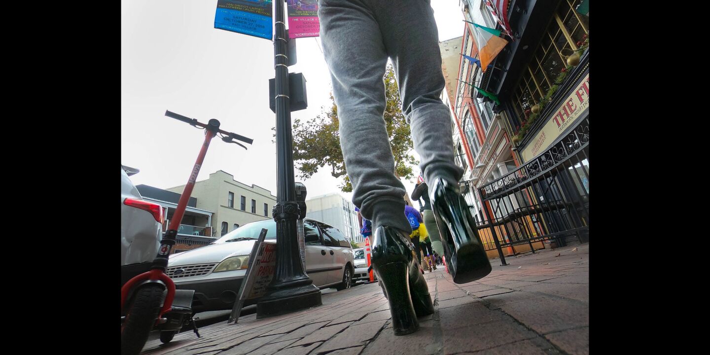 Taylor Rotunno of Rancho Penasquitos, sporting high heels was one of a couple of hundred people to walk through the Gaslamp Quarter during the YWCA'S 11th annual "Walk a Mile in Her Shoes," taking a stand against domestic violence.