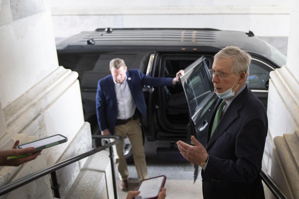 Senate Majority Leader Mitch McConnell talks to reporters at the Capitol on Monday.