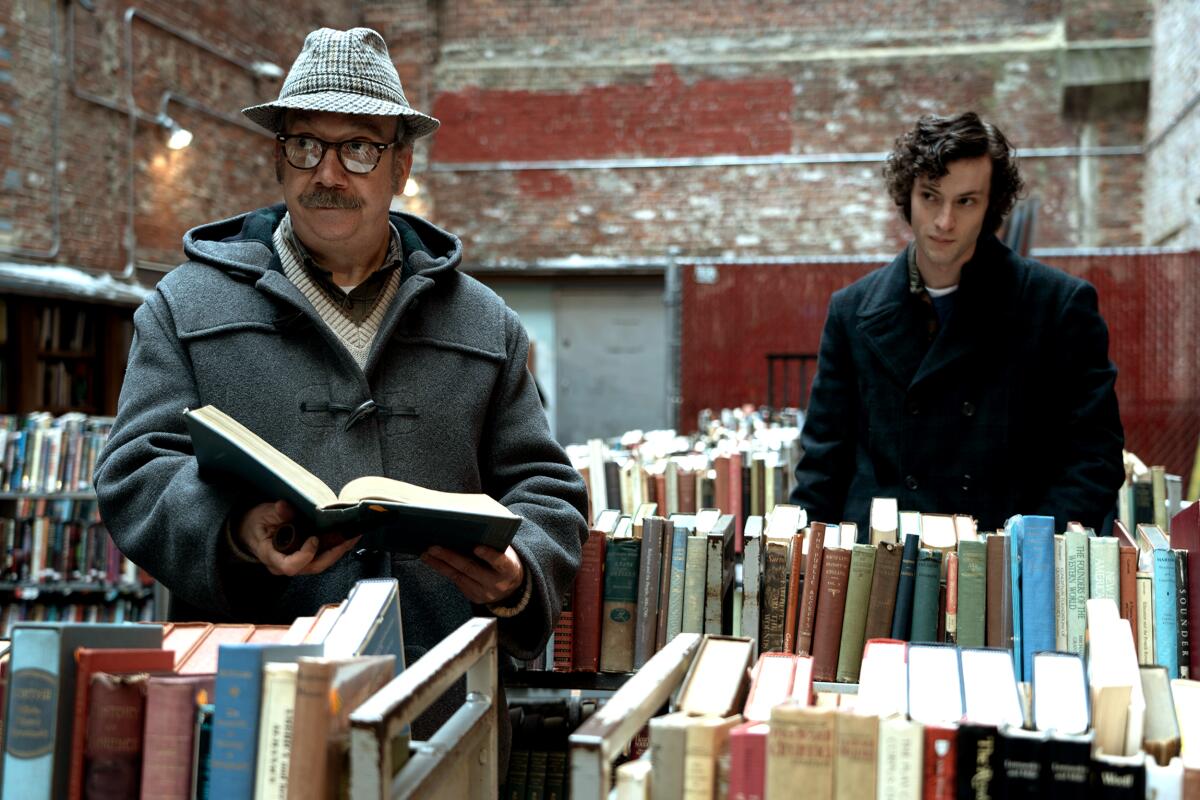 Paul Giamatti, left, and Dominic Sessa in the movie "The Holdovers."