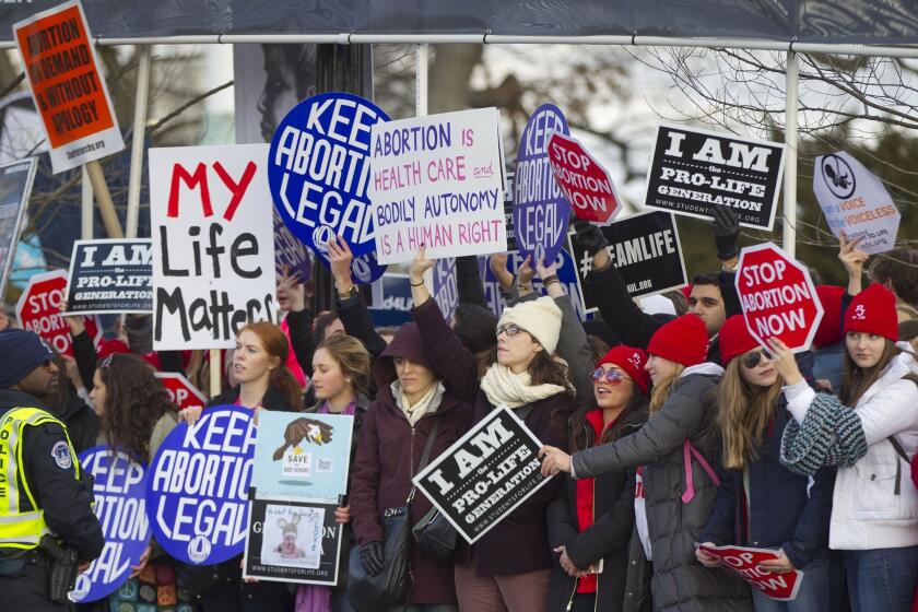 Anti-abortion and pro-choice demonstrators converge in front of the Supreme Court in January during the annual March for Life.