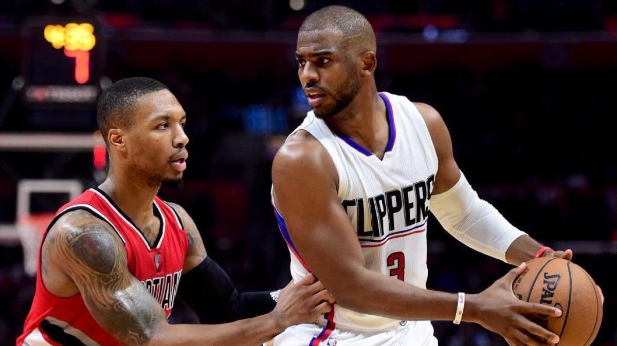 Clippers guard Chris Paul works against Trail Blazers guard Damian Lillard during a game on Dec. 12.