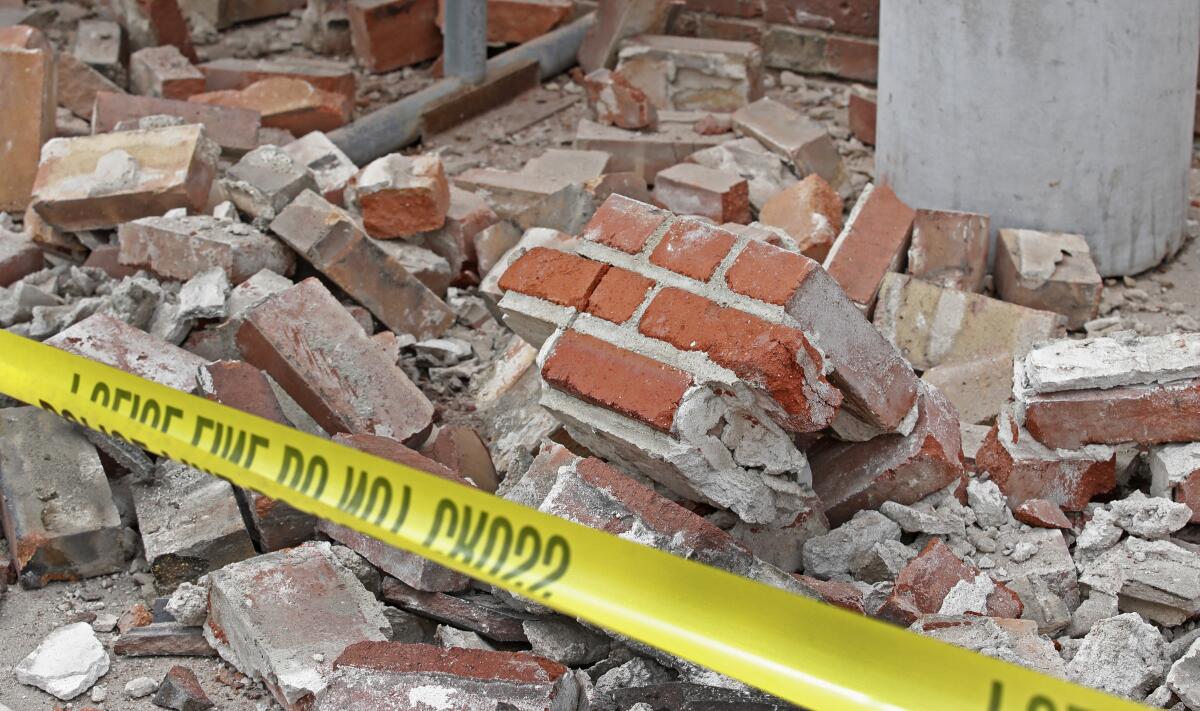 Bricks and debris lay at the base of a building damaged by an earthquake on March 18, 2020 in Magna, Utah.