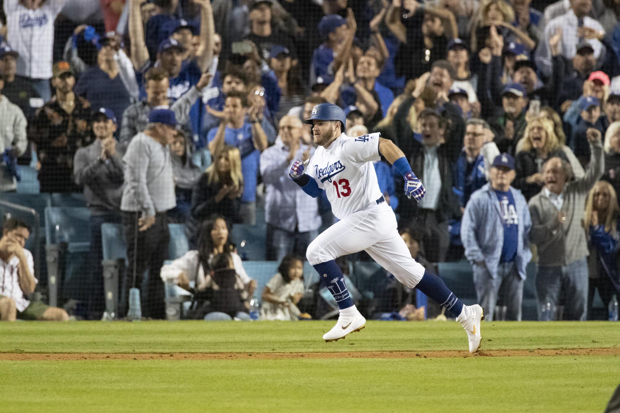 Dodgers second baseman Max Muncy runs after hitting a two-run single to give the Dodgers a 4-0 lead over the Washington Nationals in the seventh inning Thursday.