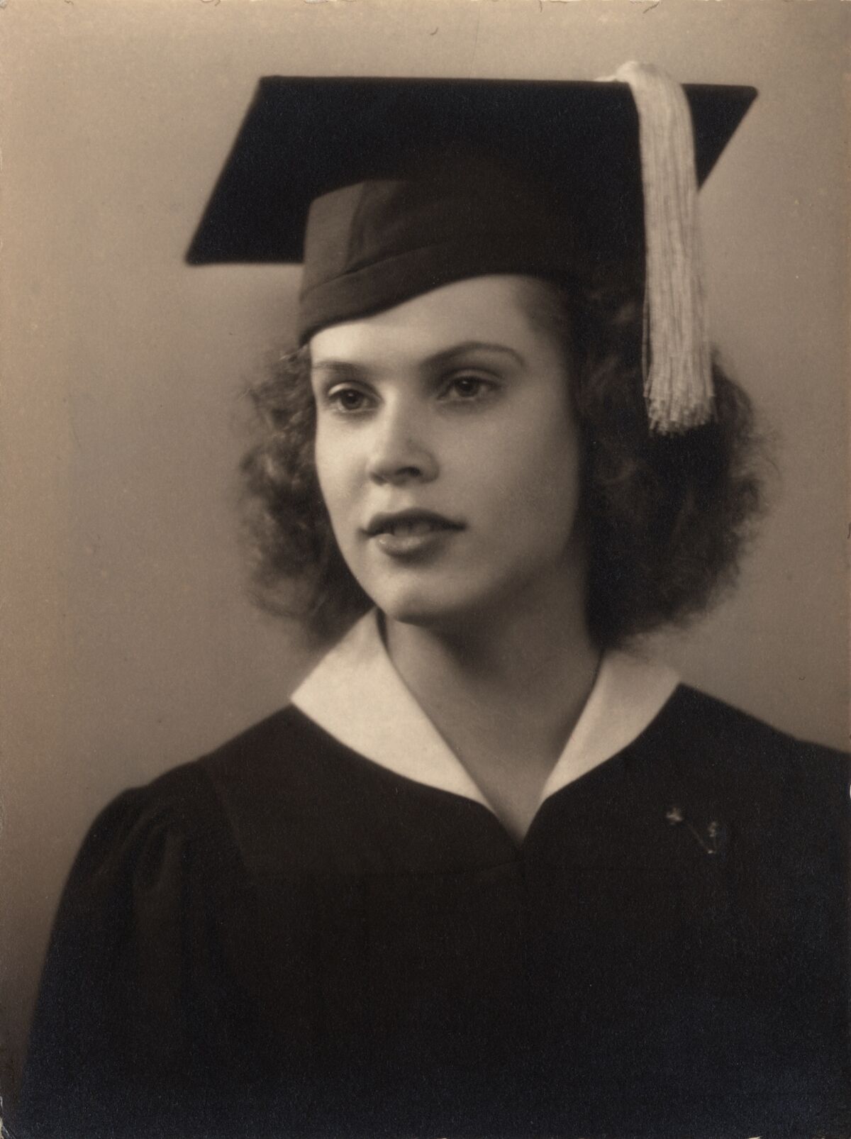 Maila Nermi in cap and gown in her high school graduation photo 