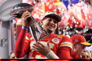 Kansas City Chiefs quarterback Patrick Mahomes celebrates with the trophy.