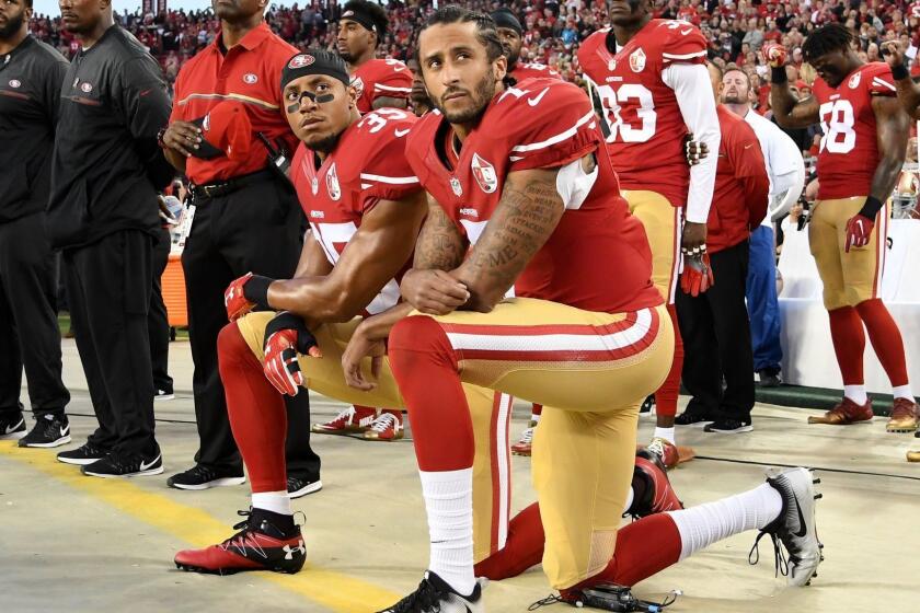 SANTA CLARA, CA - SEPTEMBER 12: Colin Kaepernick #7 and Eric Reid #35 of the San Francisco 49ers kneel in protest during the national anthem prior to playing the Los Angeles Rams in their NFL game at Levi's Stadium on September 12, 2016 in Santa Clara, California. (Photo by Thearon W. Henderson/Getty Images)