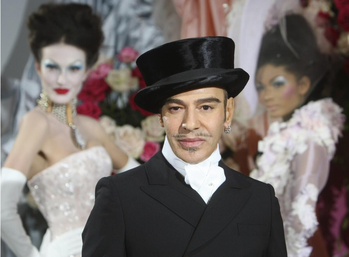 John Galliano poses at the end of the Dior Haute Couture spring/summer collection show in Paris on Jan. 25, 2010.