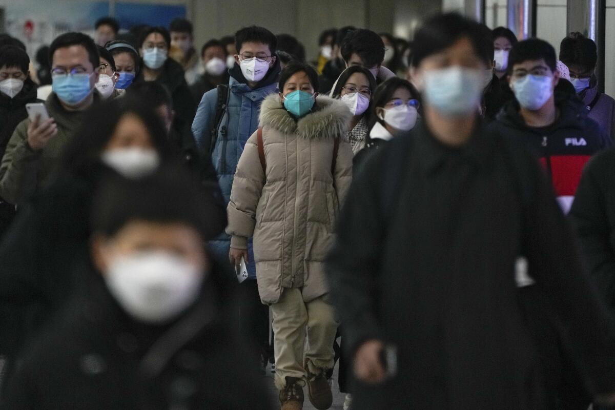 Masked commuters in a subway station