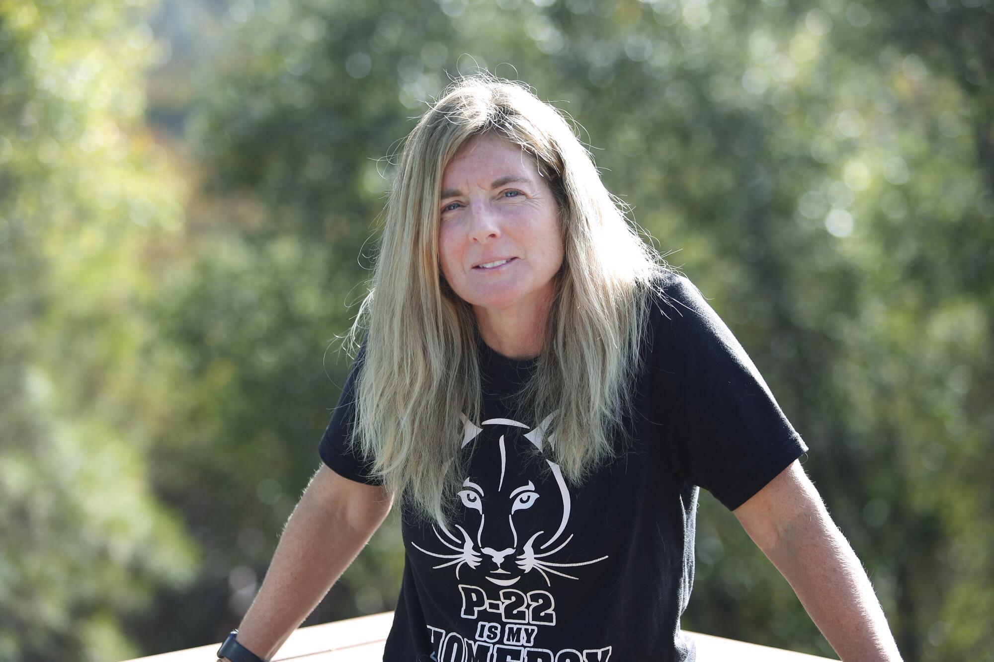 Beth Pratt, wearing a black T-shirt with a drawing of a mountain lion and the words "P-22 is my homeboy."