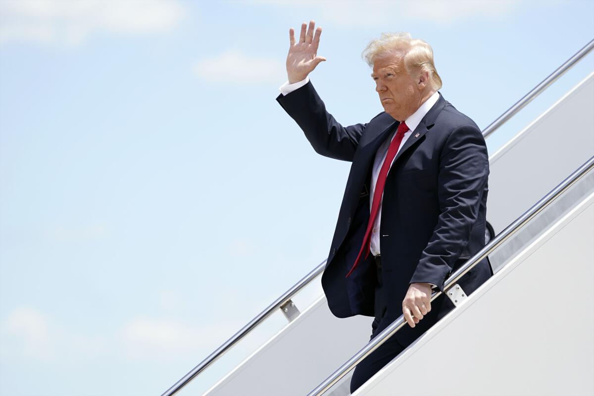 President Trump waves as he arrives in Green Bay, Wis.