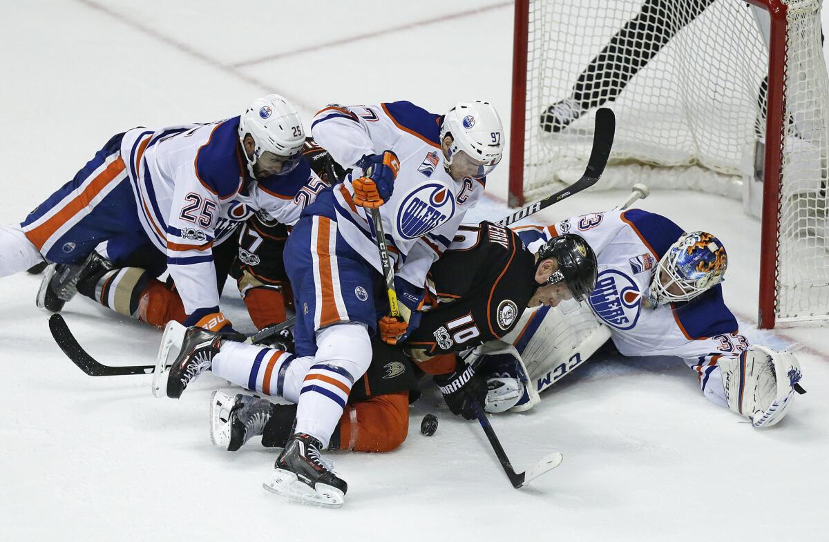 Ducks right wing Corey Perry (10) battles Oilers goalie Cam Talbot for control of the puck, which would end up on the stick of Rickard Rakell (not pictured), who tied the score with 15 seconds left in the third period of Game 5.