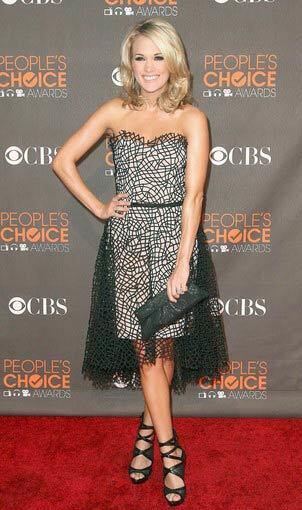 By Booth Moore, Los Angeles Times staff writer The PCA red carpet's big winner was Carrie Underwood (she also took the favorite country artist award), in a black cage-embroidered cocktail dress by Mexican-born designer Christian Cota. (Last year, Cota won Fashion Group International womens' ready-to-wear rising star award in New York.) The dress is from the Spring 2010 collection, and it features a cage-like lace made by stitching ribbons onto fabric, then melting the fabric away. I like it a lot; it's edgy and pretty at the same time, and the below-the-knee length looks fresh and entirely appropriate for the occasion. Underwood accessorized with strappy Rock N' Republic sandals and a black Lauren Merkin clutch.