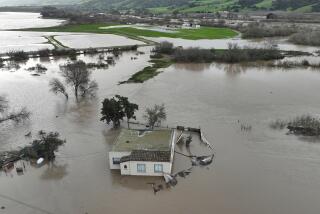 SALINAS, CALIFORNIA - JANUARY 13: In an aerial view, a home is seen submerged in floodwater as the Salinas River begins to overflow its banks on January 13, 2023 in Salinas, California. Several atmospheric river events continue to pound California with record rainfall and high winds. (Photo by Justin Sullivan/Getty Images)